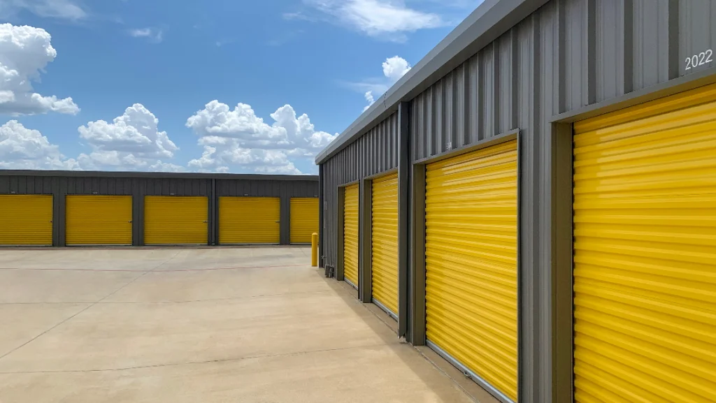 Steel storage buildings with yellow shutter doors.