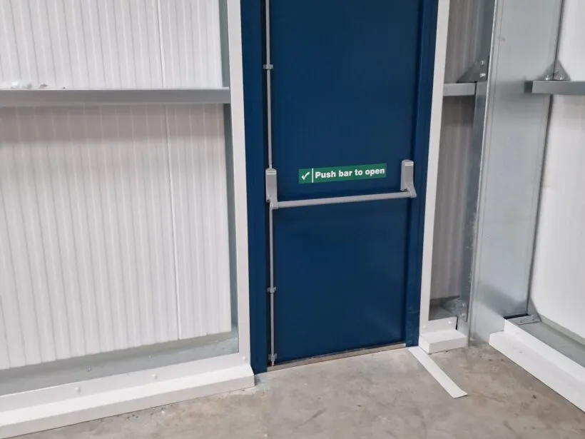 Internal view of KS1000rw composite cladding showing powder coated fire exit door.
