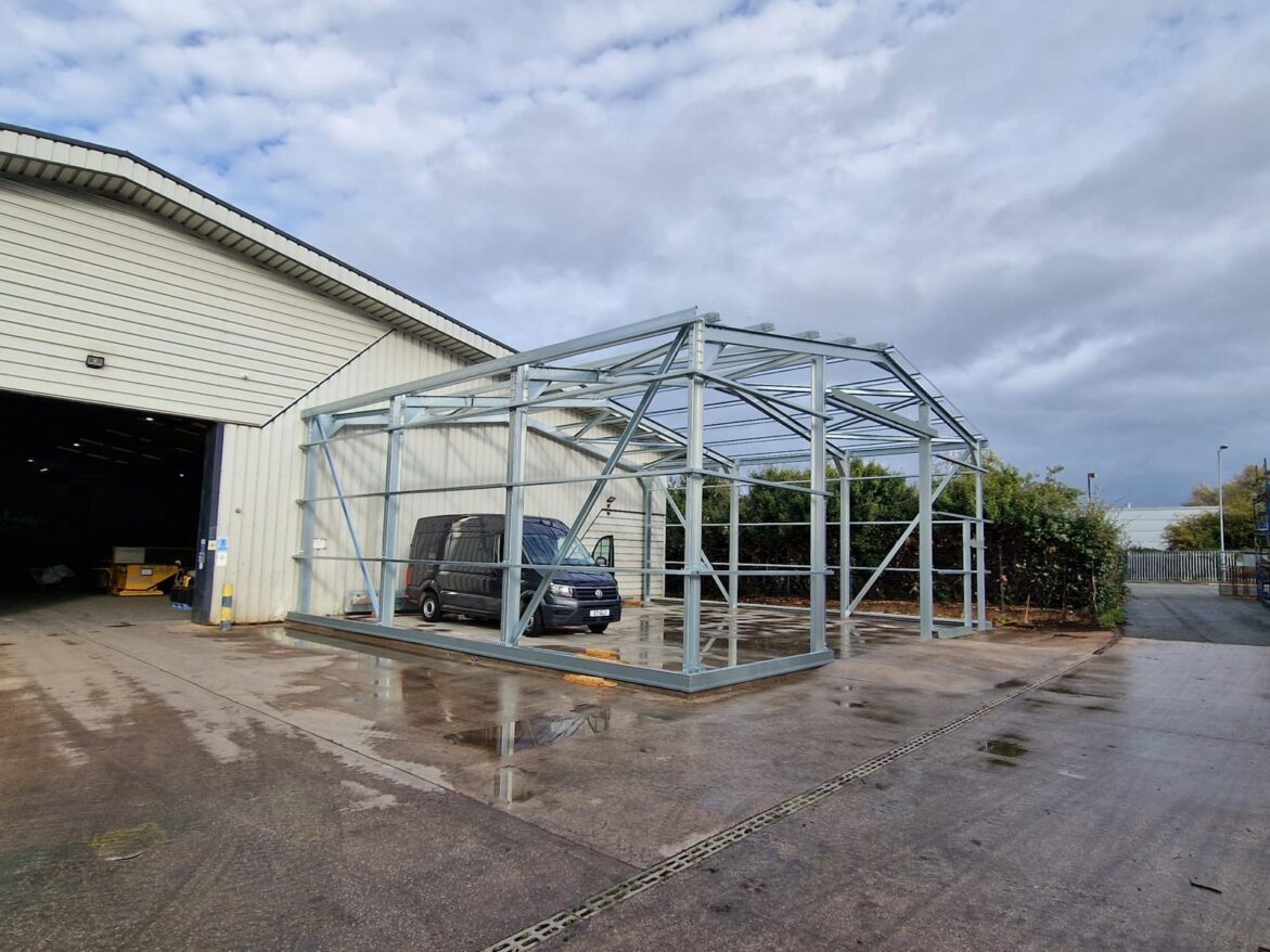 Image of cold rolled steel frame with a grey van inside.