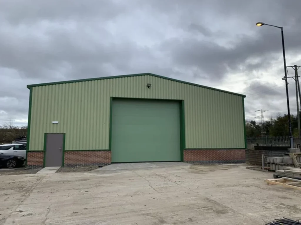 Completed green-clad steel building for Fred Mence Construction Ltd