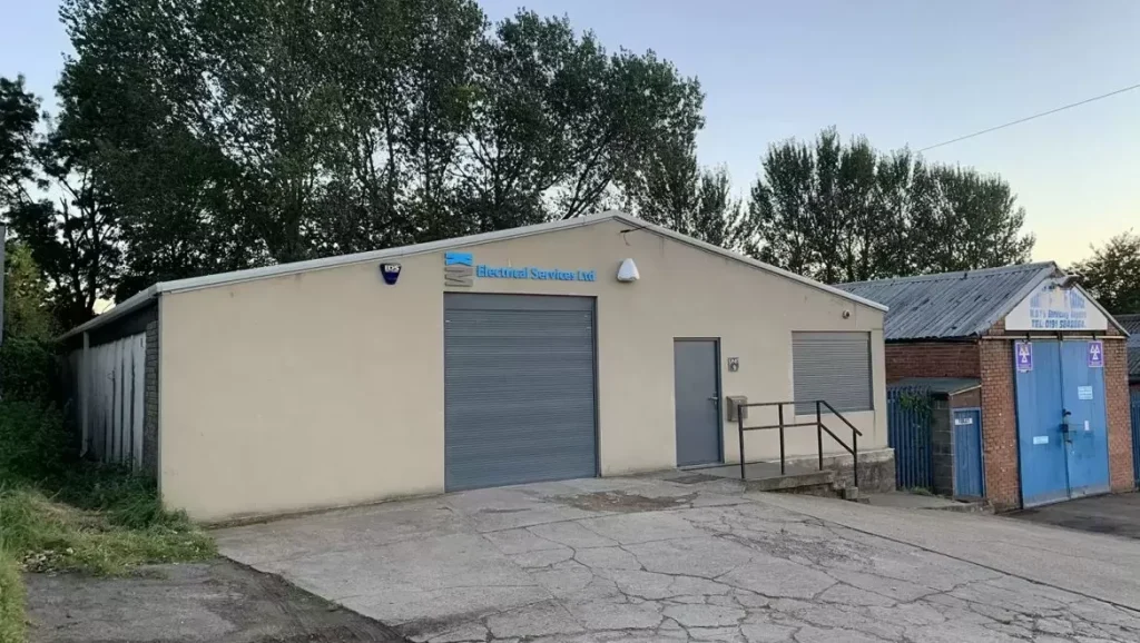 KM Electrical Services building with roller shutter door