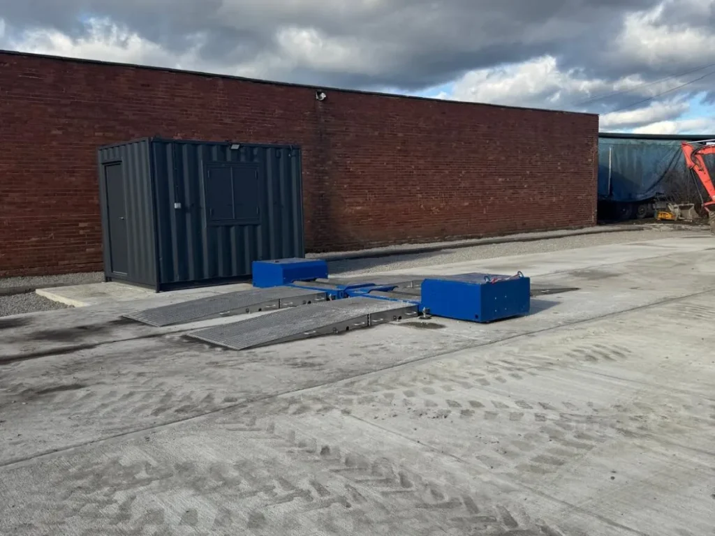 Completed break testing area with new concrete hardstanding and blue test rig at The Metal Drum Company