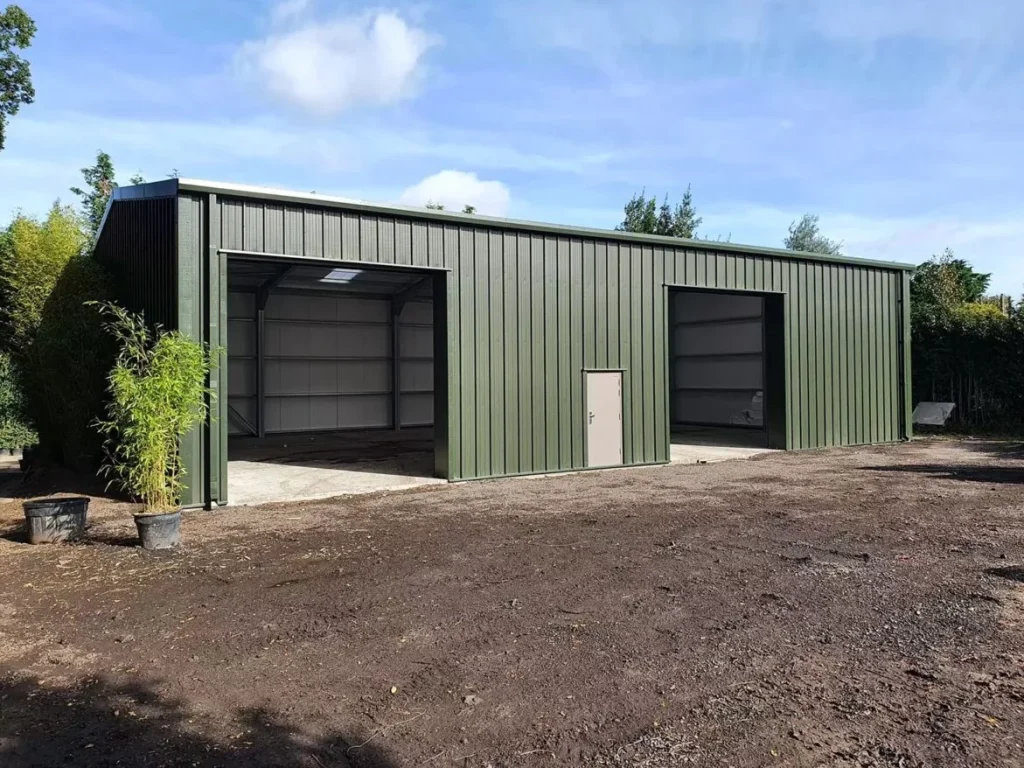 Green clad steel building with twin open bays and personnel door at Paramount Plants