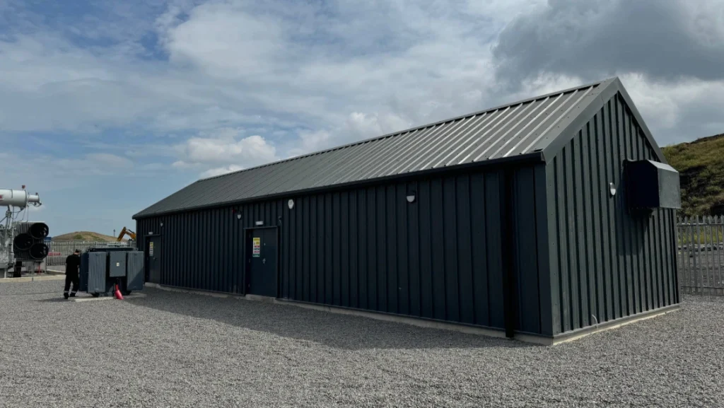 Completed dark green clad substation building with transformer compound at the SeAH site