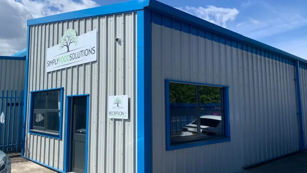 Completed steel building extension with Simply Food Solutions signage above the reception entrance