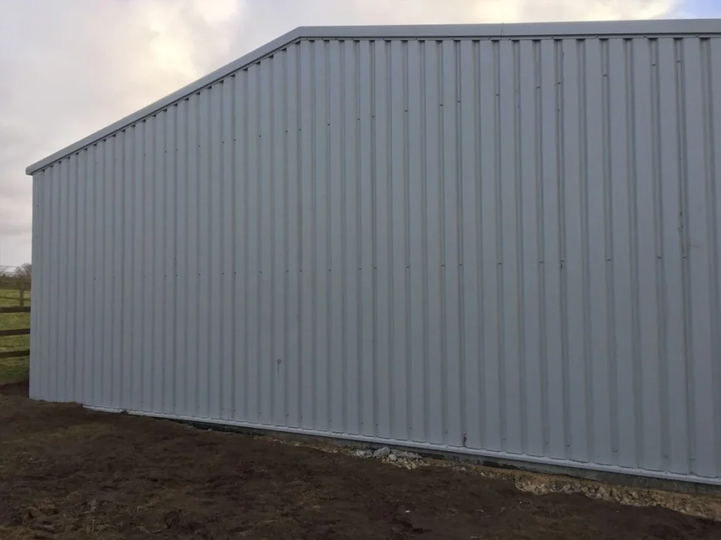 Completed grey clad steel building in a rural field for Tony Mansfield