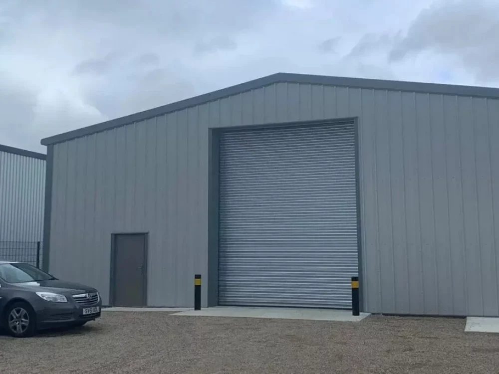 Grey hot rolled steel commercial building with a roller shutter door, built for Firth Brothers Developments in Newton Aycliffe