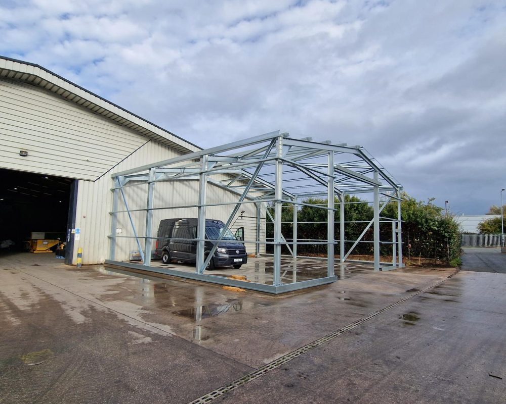 Image of cold rolled steel frame with a grey van inside.