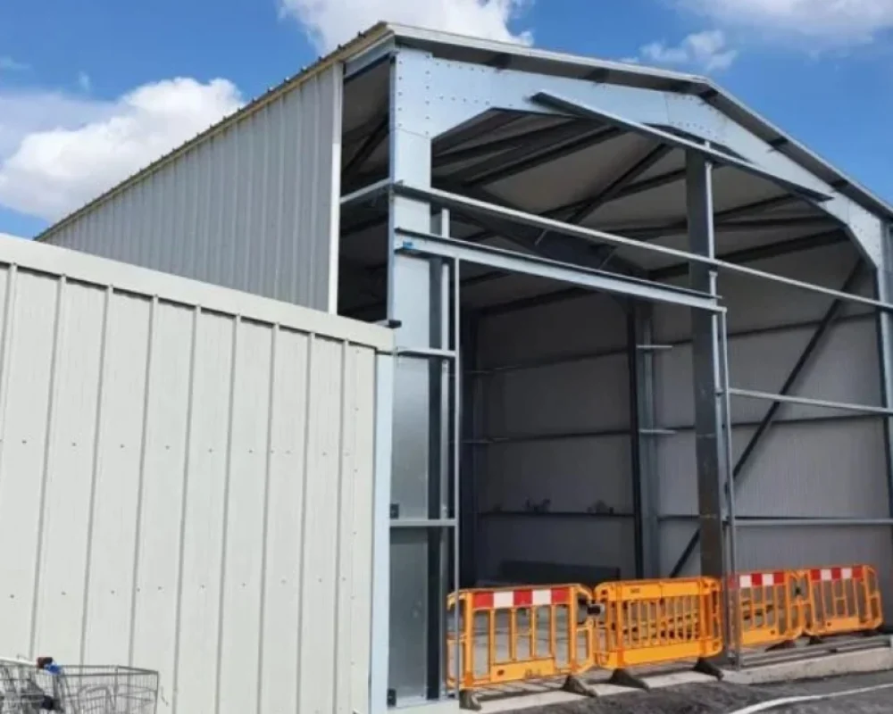 A large steel extension expands an existing facility.