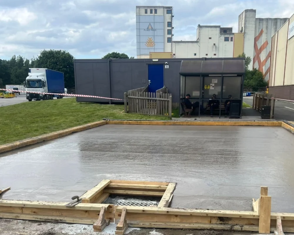 The foundation of a prefabricated steel building after groundworks have been conducted.