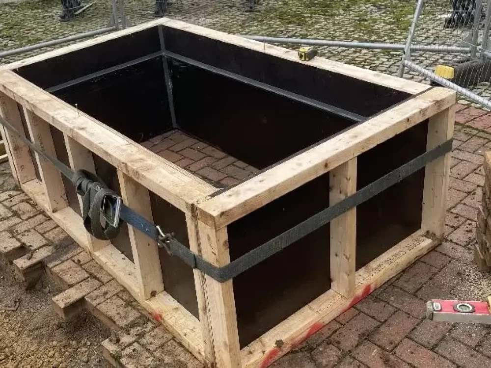 Timber formwork shuttering built and strapped ready to cast the statue plinth