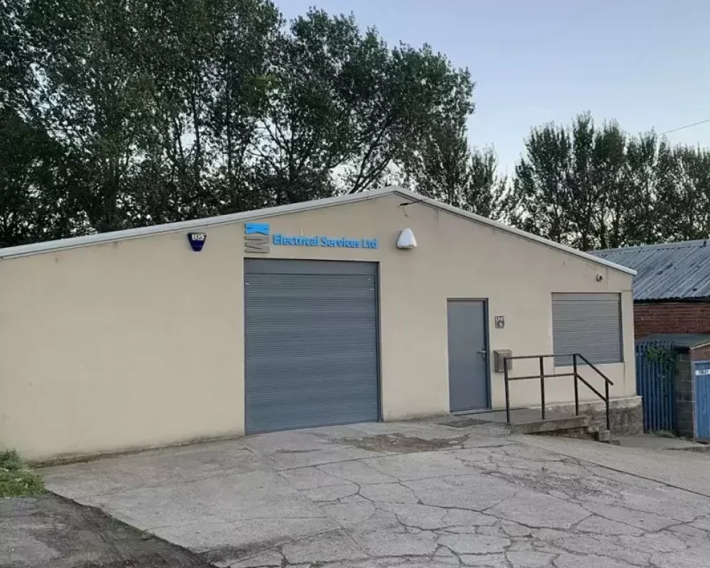 KM Electrical Services building with roller shutter door