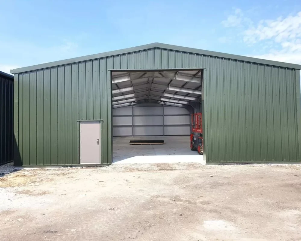 Green steel building with open bay at Lewhurst Farm (Building 2)