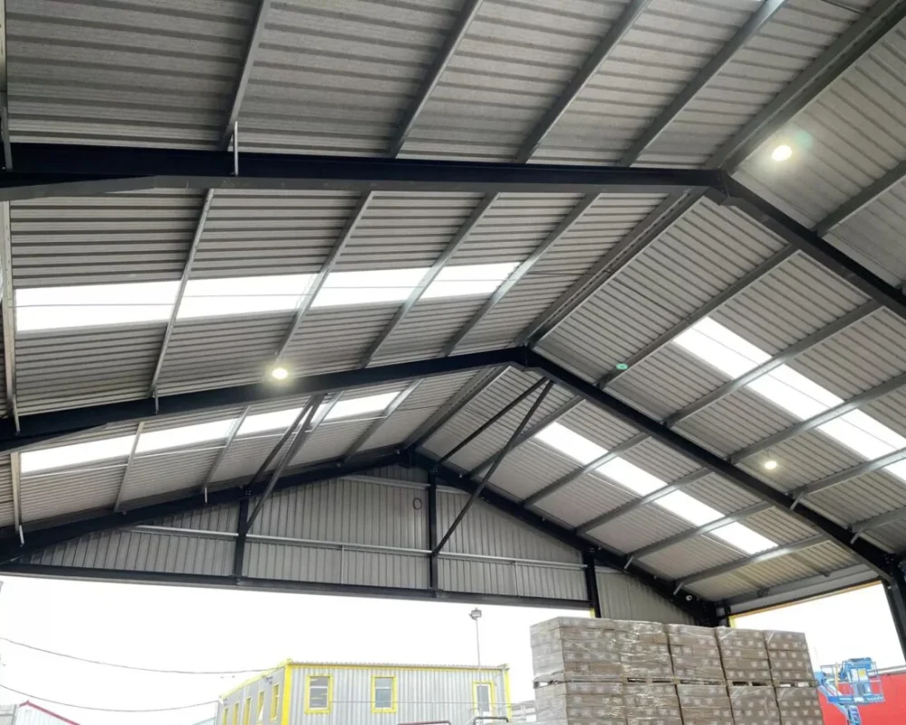 Internal view of the Mixed Freight Services steel building roof with rooflights and black portal frame
