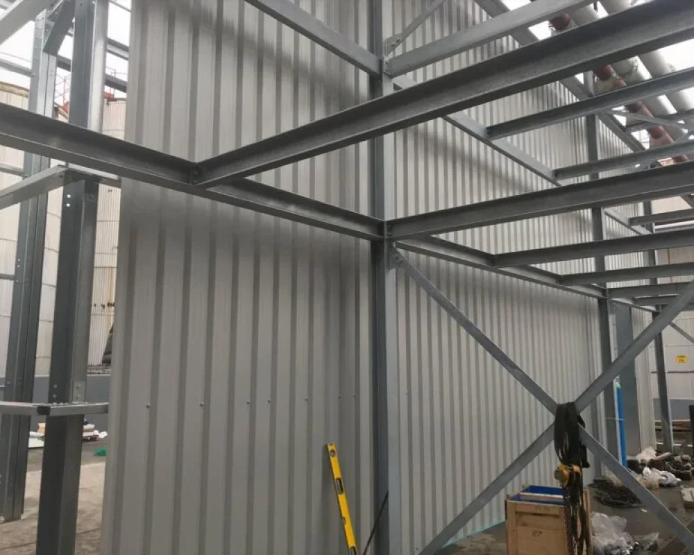Close-up of a steel frame junction with cladding partially fitted