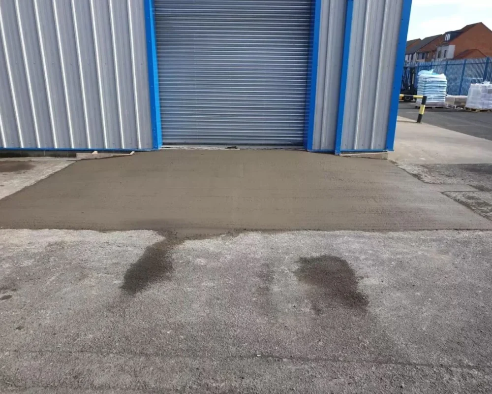 New concrete access ramp formed up to the roller shutter door at Simply Food Solutions Ltd