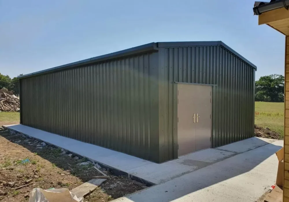 Green clad special offer steel building with double personnel doors and concrete apron