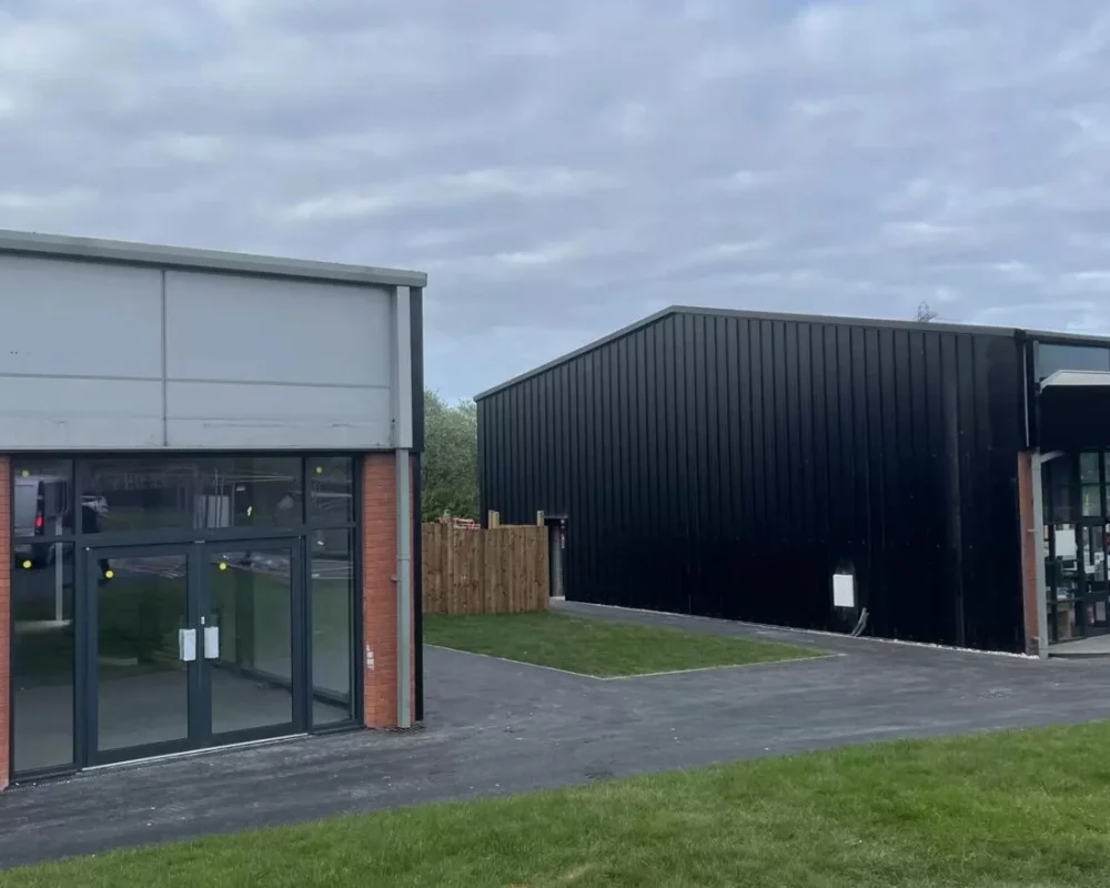 Black-clad steel building for the Starbucks & Greggs drive through