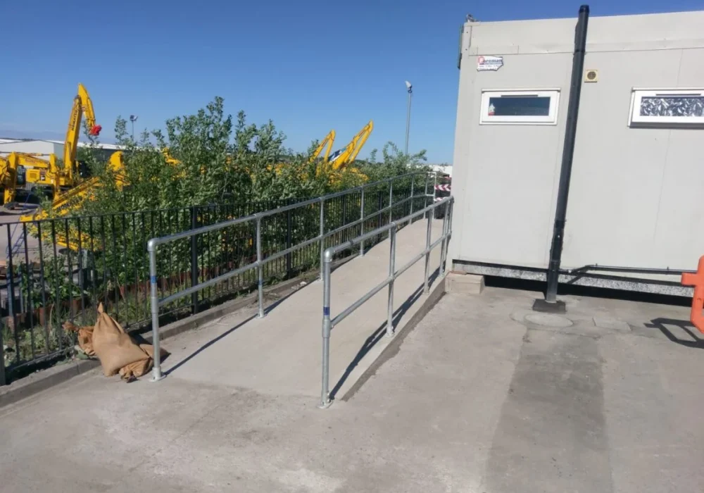 Steel handrail access ramp installed by Hamilton Steel leading to a site office