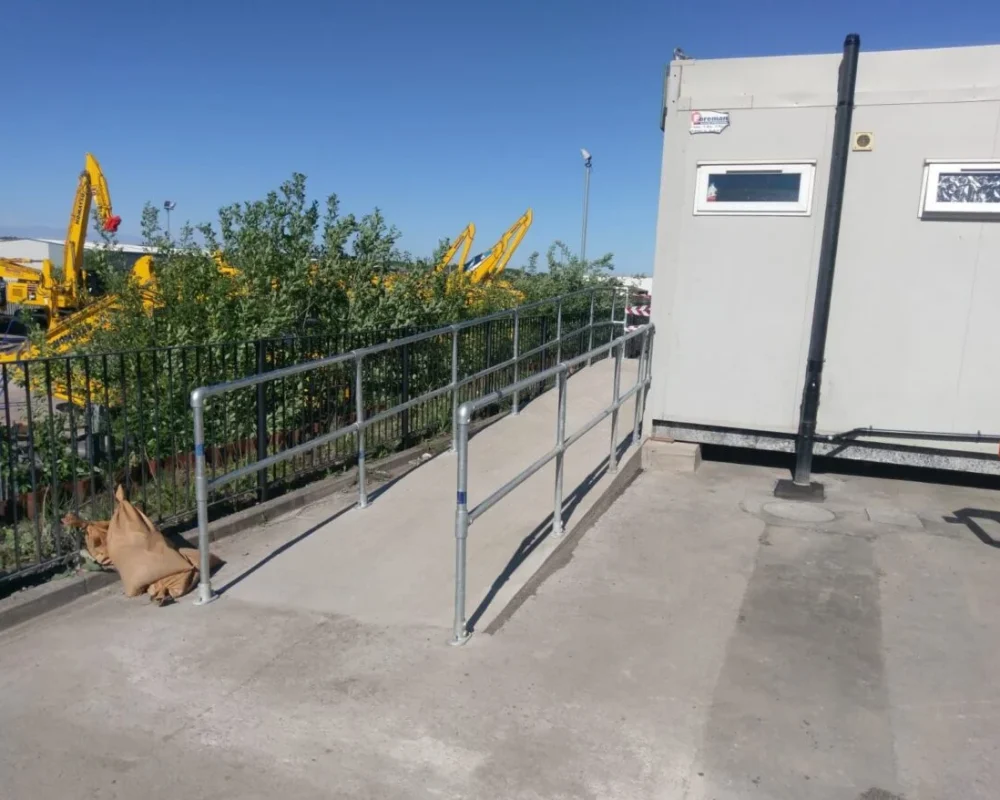 Steel handrail access ramp installed by Hamilton Steel leading to a site office