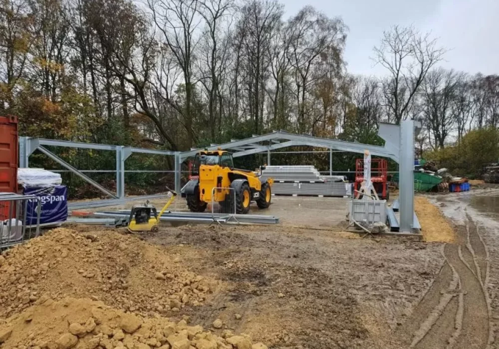 Steel frame being erected with a telehandler on site